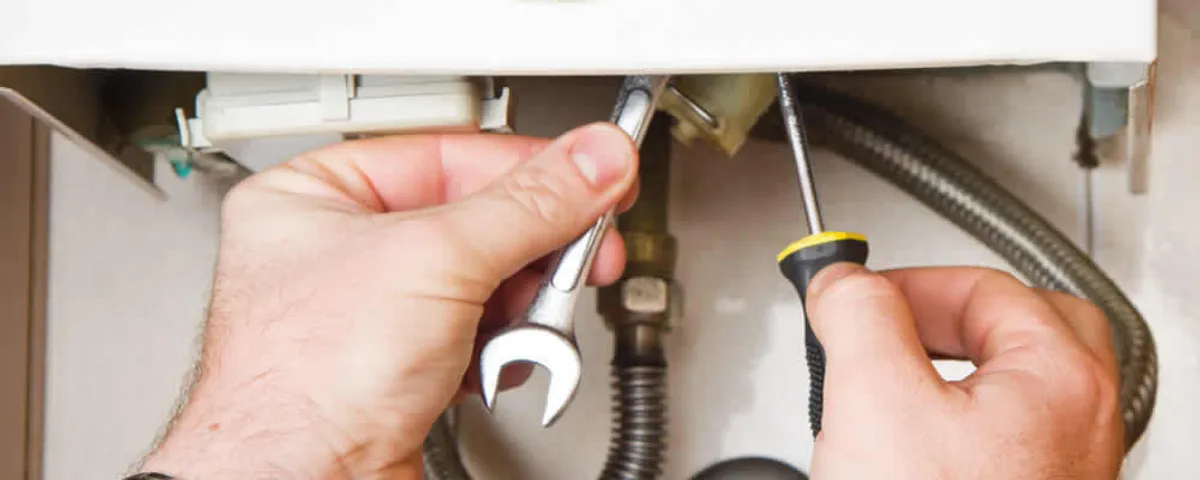 Boiler repair technician tightening pipe fittings and connections in Fort Lauderdale, FL