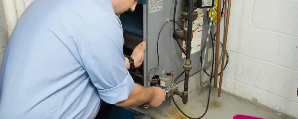 Furnace repair technician inspecting and servicing a home heating system in Fort Lauderdale, FL