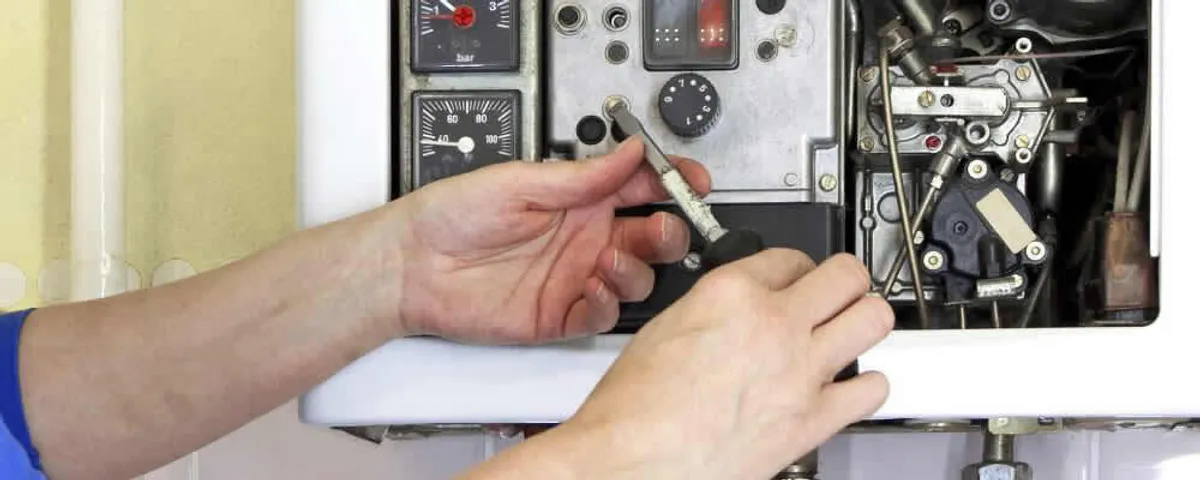 Heating repair technician adjusting boiler controls and components in Fort Lauderdale, FL