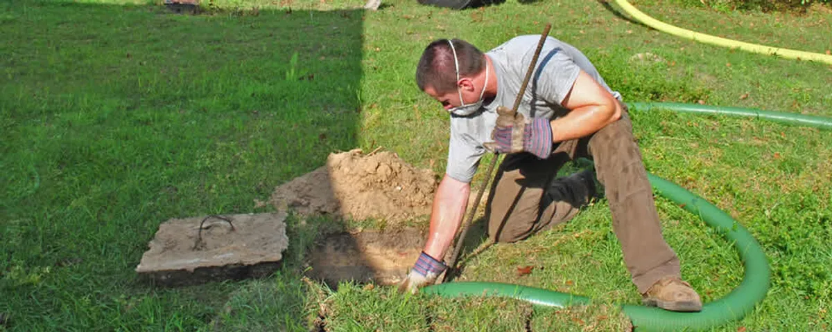 Septic pumping technician servicing a residential septic tank in Fort Lauderdale, FL