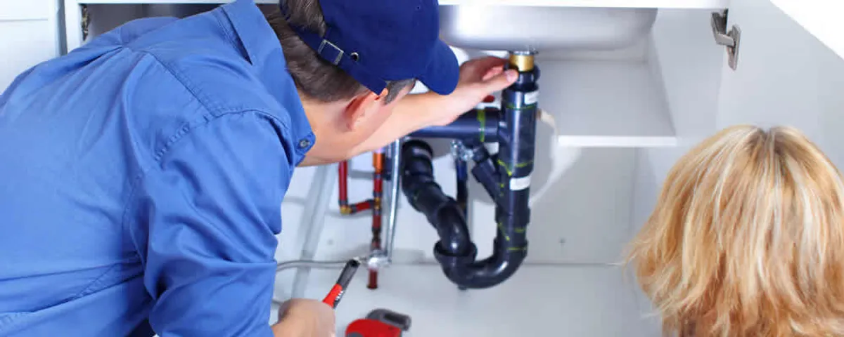 Plumber repairing under-sink drain pipes and fittings in Fort Lauderdale, FL